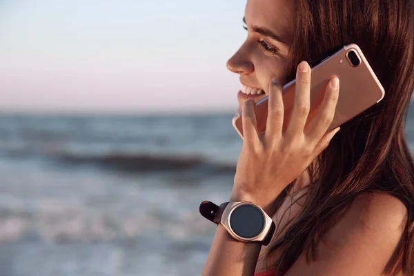 시계를 여성이 해변에서 통화를 있습니다 — 스톡 사진