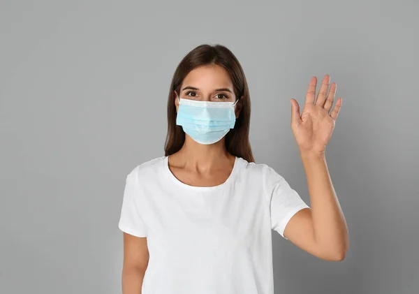 Woman Protective Mask Showing Hello Gesture Grey Background Keeping Social — Stock Photo, Image