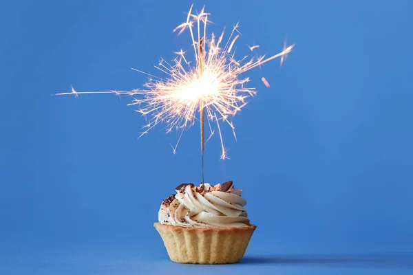 Cupcake with sparkling candle for 39th birthday or anniversary with big  number in white with yellow streamers on blue table with dark background  full Stock Photo - Alamy