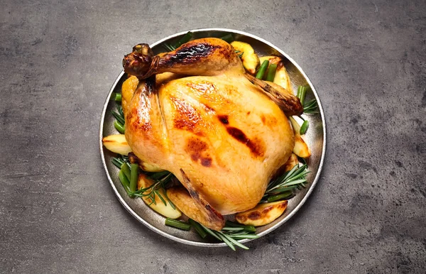 Delicious cooked turkey with garnish on grey table, top view. Thanksgiving Day celebration