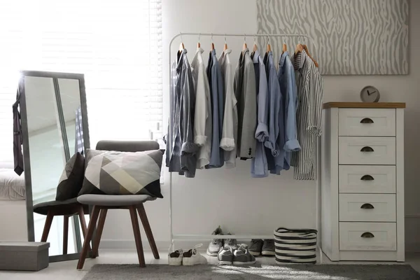 Dressing room interior with clothing rack and mirror