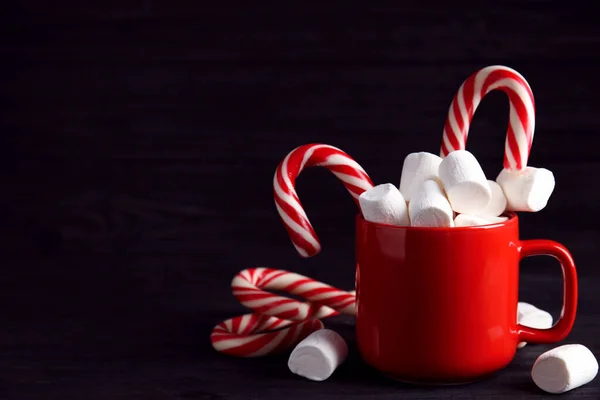 Tasse Leckeren Kakao Mit Marshmallows Und Weihnachtsbonbons Auf Schwarzem Holztisch — Stockfoto