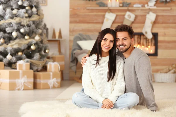 Happy couple in living room decorated for Christmas