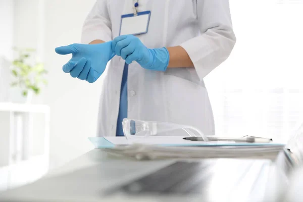 Doctor Putting Medical Gloves Table Office Closeup — Stock Photo, Image