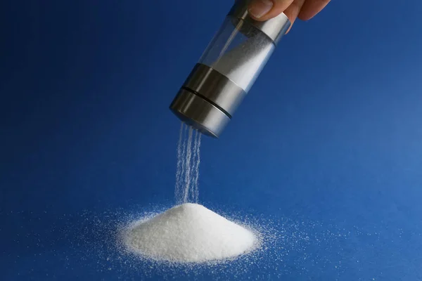 Woman Pouring Salt Shaker Blue Background Closeup — Stock Photo, Image