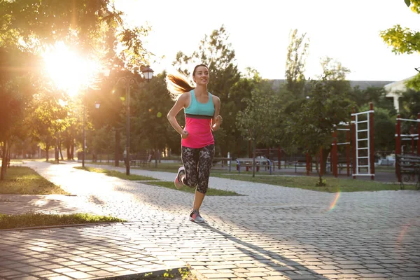 朝の若い女性は公園で走る — ストック写真