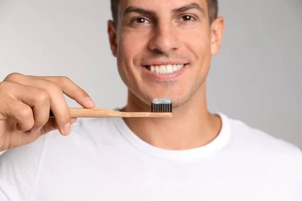 Man Som Håller Tandborste Med Pasta Ljus Bakgrund Närbild — Stockfoto