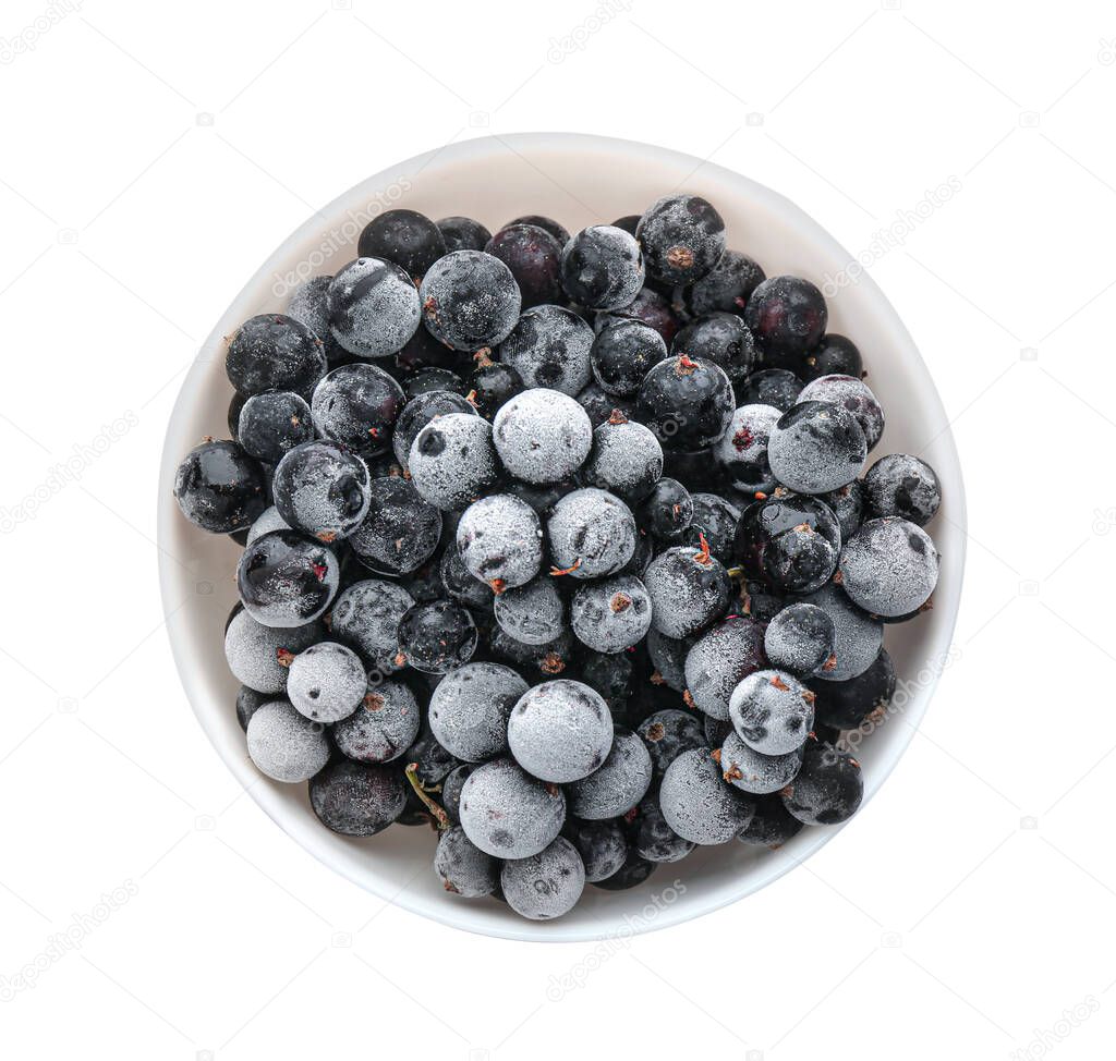 Tasty frozen black currants in bowl isolated on white, top view