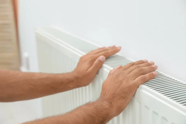 Man Warming Hands Heating Radiator White Wall Closeup — Stock Photo, Image