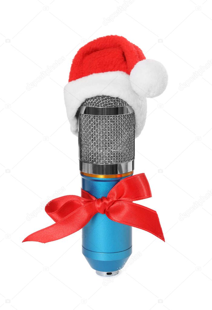 Microphone with Santa hat and red bow isolated on white. Christmas music