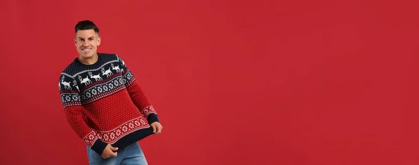 Happy Man Showing His Christmas Sweater Red Background — Stock Photo, Image