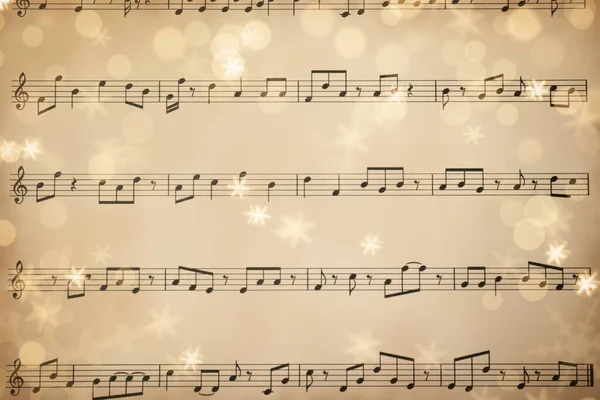 以圣诞乐谱为背景 雪花和防震效果的旧乐谱的顶部视图 — 图库照片
