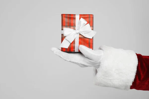 Santa Claus Holding Christmas Gift Light Grey Background Closeup Hand — Stock Photo, Image