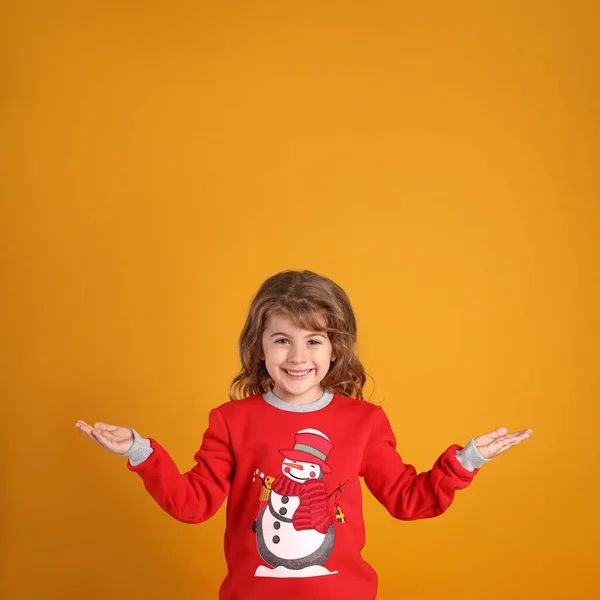 Cute Little Girl Red Christmas Sweater Smiling Orange Background — Stock Photo, Image
