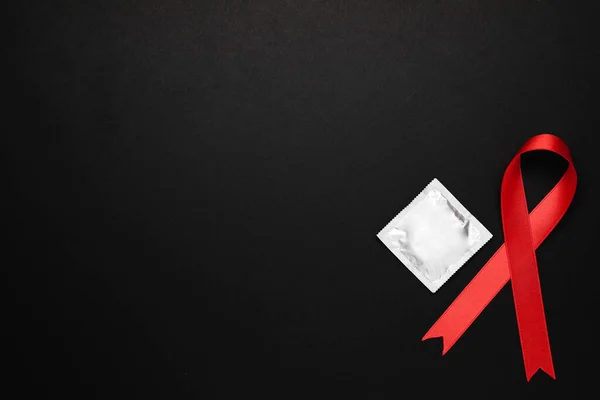 Red Ribbon Condom Black Background Flat Lay Space Text Aids — Stock Photo, Image