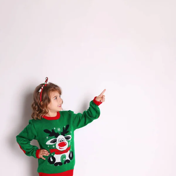 Cute Little Girl Green Christmas Sweater Pointing White Background — Stock Photo, Image