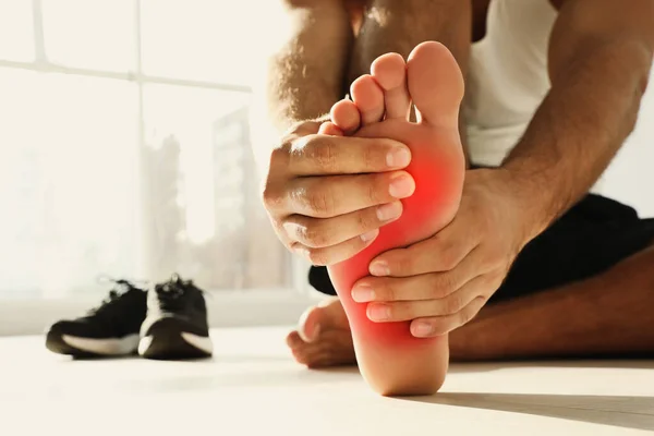 Man Suffering Foot Pain Floor Indoors Closeup — Stock Photo, Image