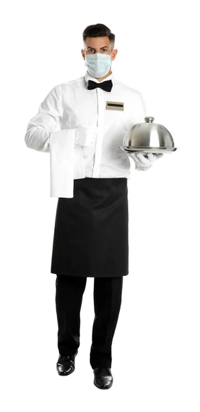 Waiter in medical face mask holding tray with lid on white background