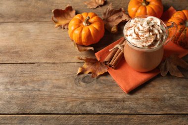 Ahşap masada lezzetli balkabaklı latte. Metin için boşluk