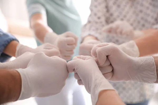 People White Medical Gloves Joining Fists Light Background Closeup — Stock Photo, Image