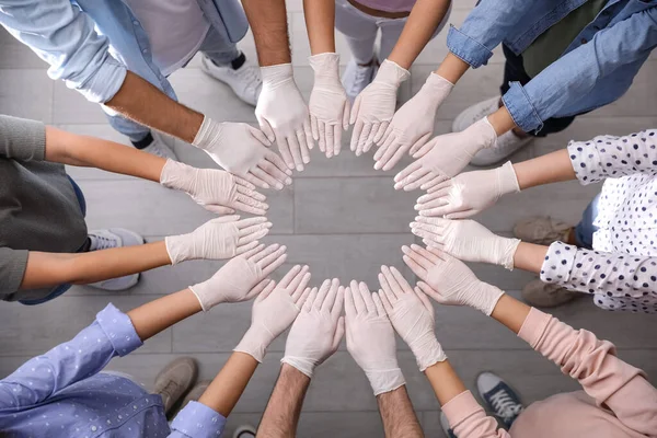 People White Medical Gloves Joining Hands Indoors Top View — Stock Photo, Image