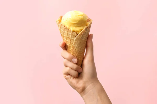 ピンクの背景においしい黄色のアイスクリームとワッフルコーンを保持女性 クローズアップ — ストック写真