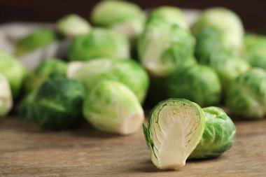 Fresh Brussels sprouts on wooden table, closeup clipart
