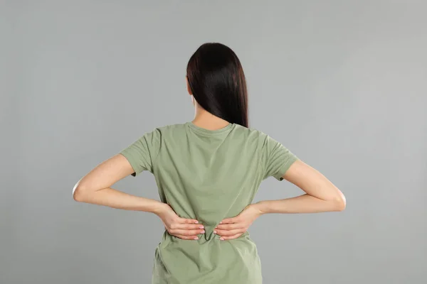 Woman Suffering Lower Back Pain Light Grey Background Visiting Orthopedist — Stock Photo, Image