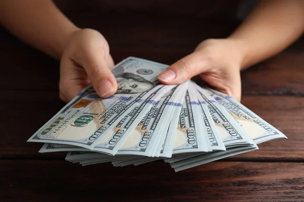 Woman Holding Dollar Banknotes Wooden Table Closeup — Stock Photo, Image