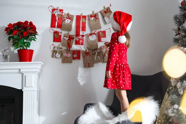 Cute Little Girl Santa Hat Taking Gift Christmas Advent Calendar — Stock Photo, Image