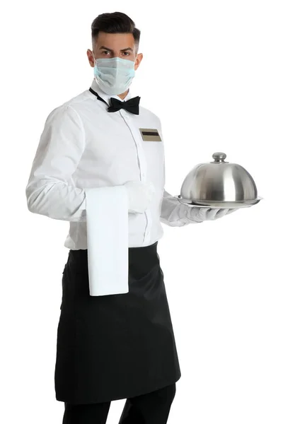 Waiter in medical face mask holding tray with lid on white background