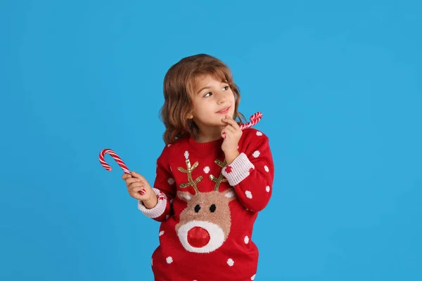 Cute Little Girl Christmas Sweater Holding Sweet Candy Canes Blue — Stock Photo, Image