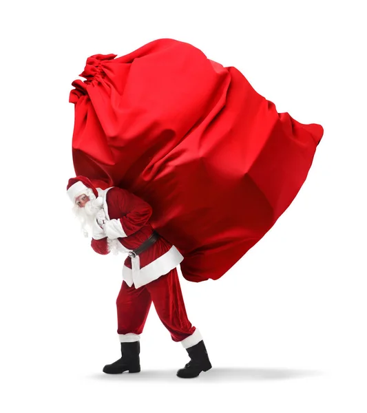 Санта Клаус Несет Огромную Красную Сумку Полную Рождественских Подарков Белом — стоковое фото