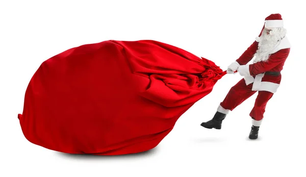Санта Клаус Тянет Огромную Красную Сумку Полную Рождественских Подарков Белом — стоковое фото