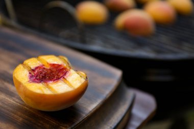 Lezzetli ızgara şeftalinin yarısı ahşap masada, yakın plan.