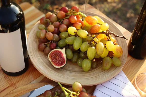 Dışarıdaki Ahşap Masada Piknik Için Kırmızı Şarap Meyve Servis Edilir — Stok fotoğraf