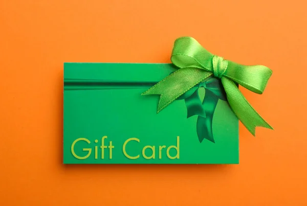 Gift Card Bow Orange Background Top View — Stock Photo, Image