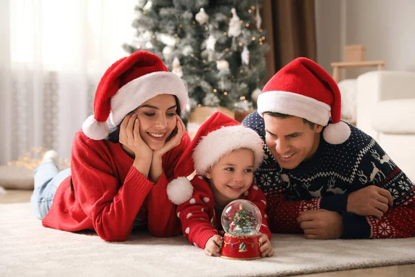 Family Santa Hats Playing Snow Globe Home — Stock Photo, Image