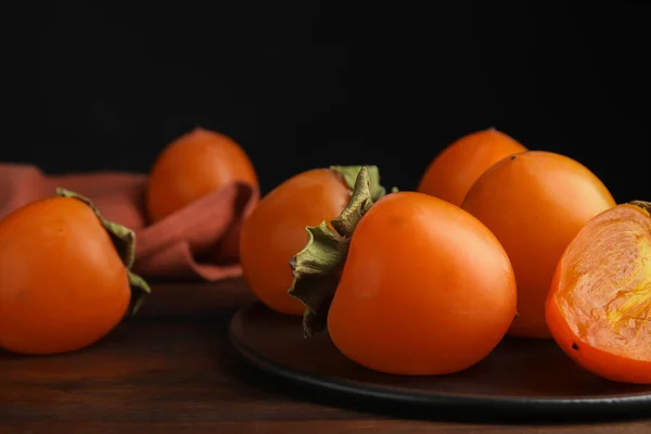 Tasty Ripe Persimmons Brown Wooden Table Closeup — Stock Photo, Image