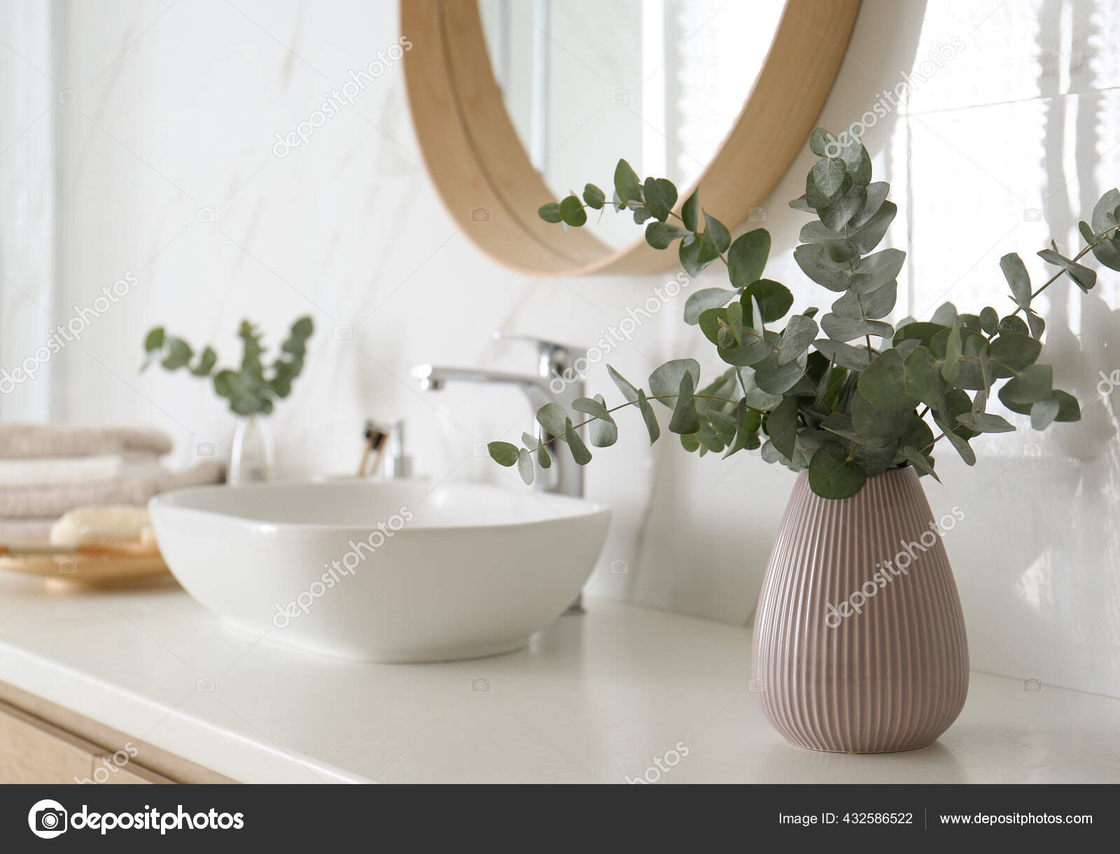 eucalyptus in vase in bathroom
