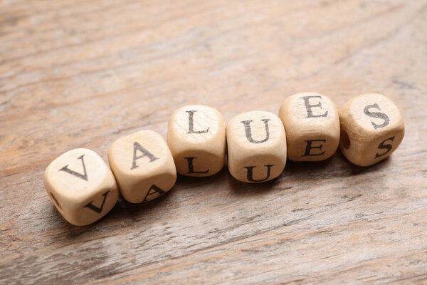 Beads with word VALUES on wooden background