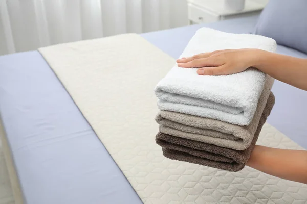 Woman Putting Soft Clean Towels Bed Indoors Closeup Space Text — Stock Photo, Image