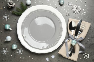 Beautiful Christmas table setting and festive decor on grey background, flat lay