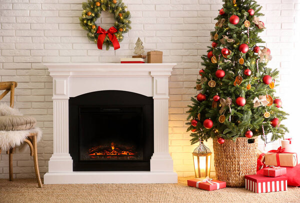 Beautiful living room interior with decorated Christmas tree and modern fireplace