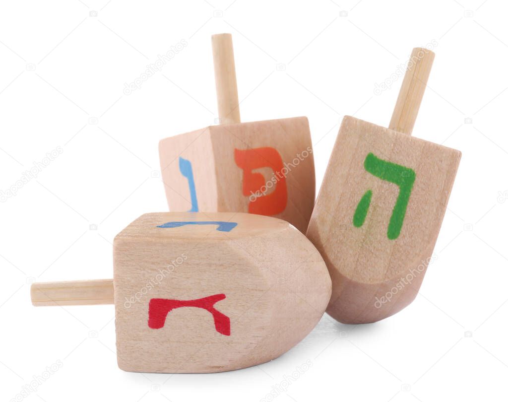 Wooden Hanukkah traditional dreidels on white background
