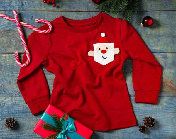 Red Baby Jumper Christmas Decorations Blue Wooden Background Flat Lay — Stock Photo, Image