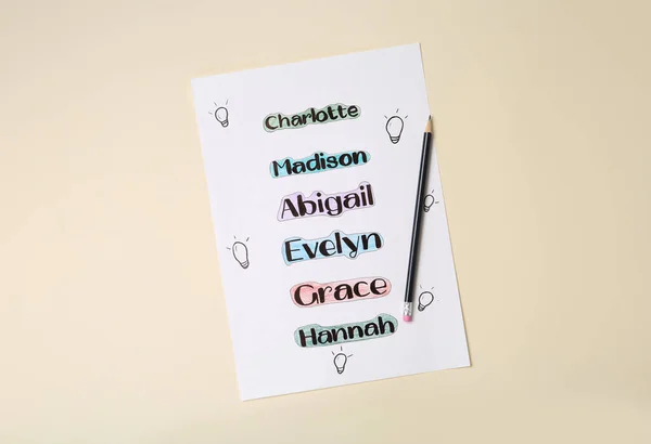 Liste Der Verschiedenen Babynamen Und Bleistift Auf Beigem Hintergrund Draufsicht — Stockfoto