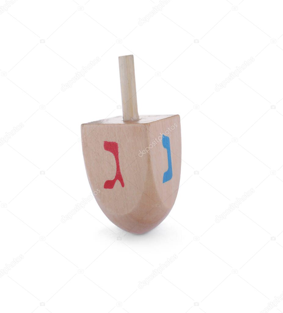 Wooden Hanukkah traditional dreidel with letters Nun and Gimel isolated on white