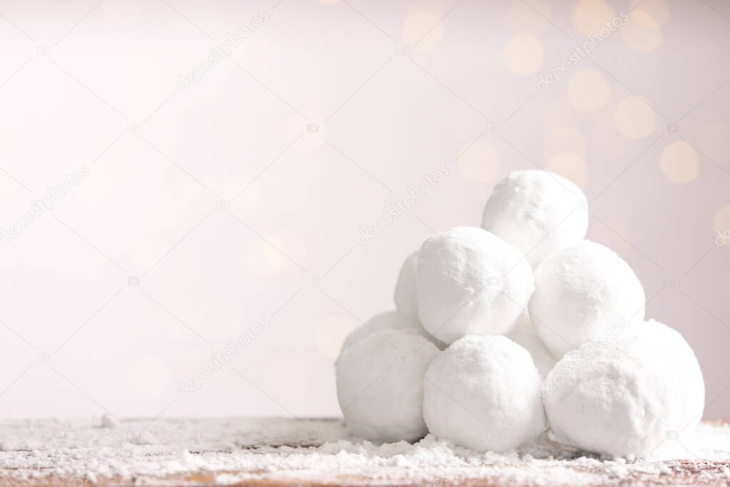 Snowballs on table against blurred lights, space for text