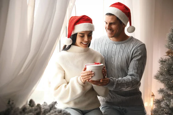 Couple Santa Hats Holding Gift Box Christmas Tree — Stock Photo, Image